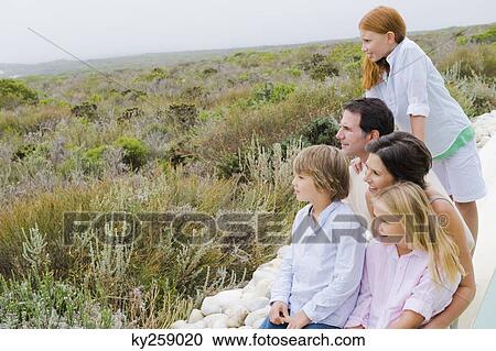 Family sitting at the poolside and admiring the view View Large Photo Image Stock Image - Family sitting at the poolside and admiring the view. Fotosearch