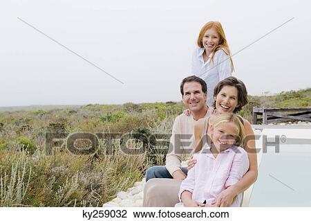 Family sitting at the poolside View Large Photo Image Stock Image - Family sitting at the poolside. Fotosearch