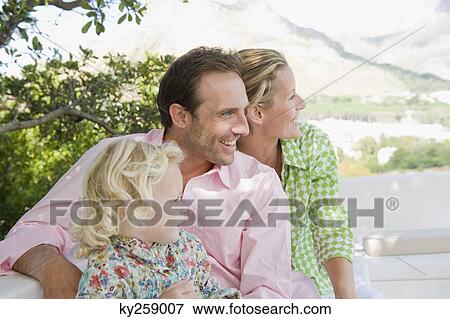 Family smiling on a terrace View Large Photo Image Stock Photo - Family smiling on a terrace. Fotosearch