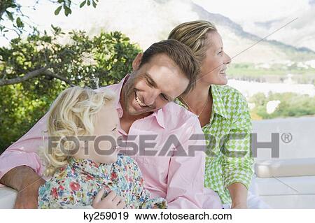 Family smiling on a terrace View Large Photo Image Stock Photo - Family smiling on a terrace. Fotosearch