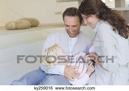 Girl playing with her parents View Large Photo Image Stock Photograph - Girl playing with her parents. Fotosearch