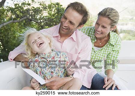 Stock Photography - Girl smiling with her parents. Fotosearch
