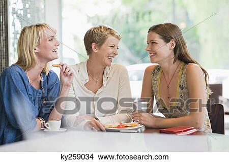 Three women sitting in a restaurant View Large Photo Image Picture - Three women sitting in a restaurant. Fotosearch