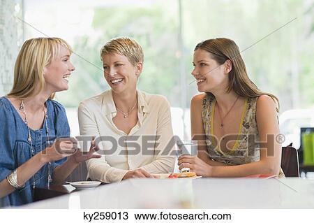 Three women sitting in a restaurant View Large Photo Image Stock Image - Three women sitting in a restaurant. Fotosearch