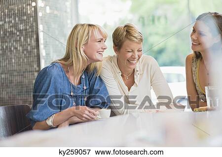 Three women sitting in a restaurant View Large Photo Image Stock Photo - Three women sitting in a restaurant. Fotosearch