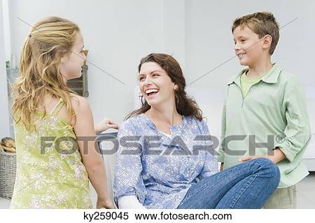 Woman smiling with her children View Large Photo Image Stock Photography - Woman smiling with her children. Fotosearch