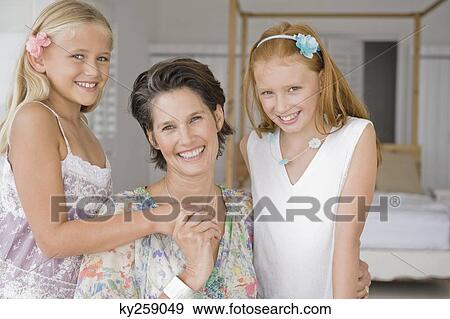 Woman smiling with her two daughters View Large Photo Image Stock Photo - Woman smiling with her two daughters. Fotosearch