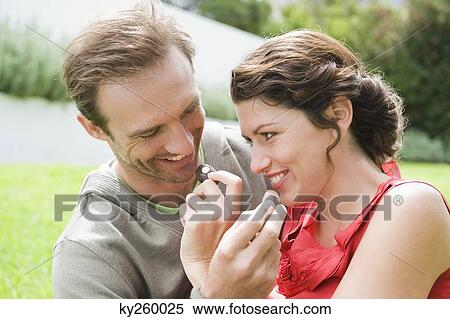 Couple feeding chocolates to each other and smiling View Large Photo Image Stock Photography - Couple feeding chocolates to each other and smiling. Fotosearch