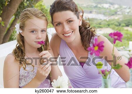 Portrait of a woman smiling with her daughter View Large Photo Image Stock Photo - Portrait of a woman smiling with her daughter. Fotosearch