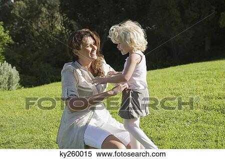 Stock Photography - Woman playing with her daughter. Fotosearch
