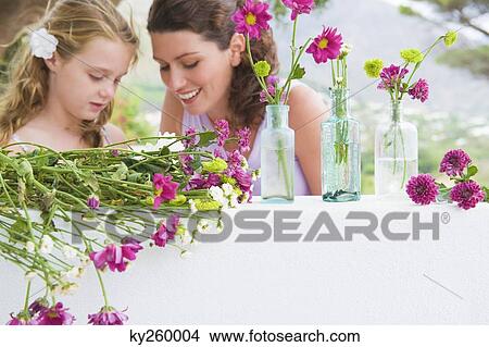 Picture - Woman smiling with her daughter. Fotosearch