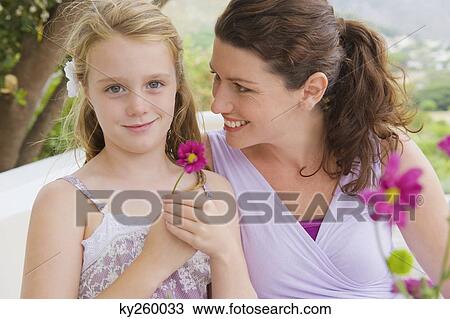 Woman smiling with her daughter View Large Photo Image Stock Image - Woman smiling with her daughter. Fotosearch