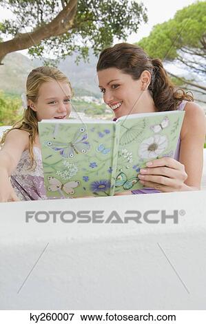 Woman teaching her daughter View Large Photo Image Stock Photo - Woman teaching her daughter. Fotosearch