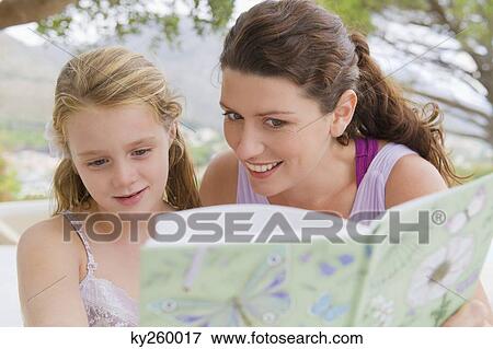 Woman teaching her daughter View Large Photo Image Stock Photo - Woman teaching her daughter. Fotosearch