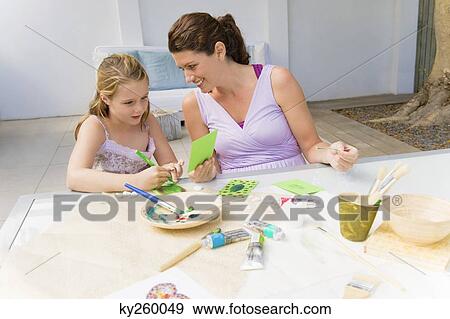 Woman teaching her daughter View Large Photo Image Stock Photo - Woman teaching her daughter. Fotosearch