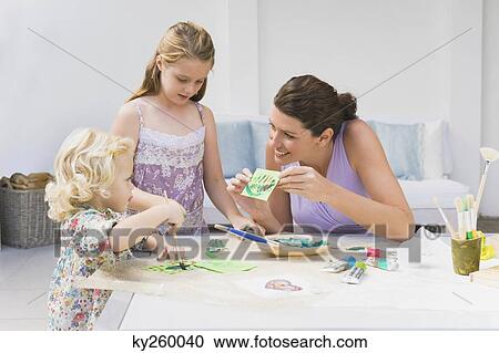 Woman teaching her two daughters View Large Photo Image Stock Image - Woman teaching her two daughters. Fotosearch