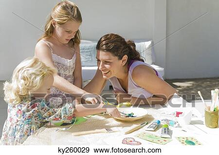 Stock Photo - Woman teaching her two daughters. Fotosearch