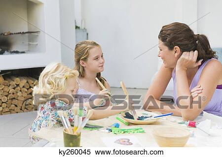 Woman teaching her two daughters View Large Photo Image Stock Photography - Woman teaching her two daughters. Fotosearch