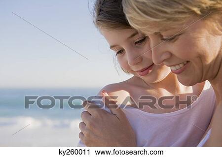 Woman with her daughter enjoying vacations on the beach View Large Photo Image Stock Image - Woman with her daughter enjoying vacations on the beach. Fotosearch