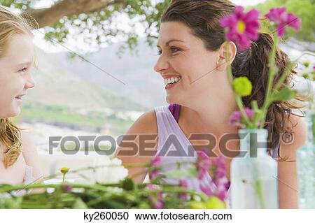 Woman with her daughter looking at each other View Large Photo Image Stock Image - Woman with her daughter looking at each other. Fotosearch