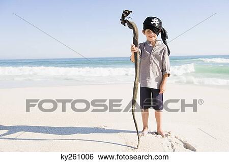 Boy in pirate costume standing on the beach View Large Photo Image Stock Photograph - Boy in pirate costume standing on the beach. Fotosearch