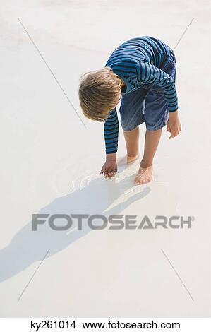 Boy playing in an infinity pool View Large Photo Image Picture - Boy playing in an infinity pool. Fotosearch