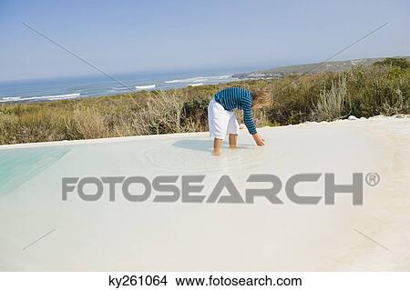 Boy playing in an infinity pool View Large Photo Image Picture - Boy playing in an infinity pool. Fotosearch