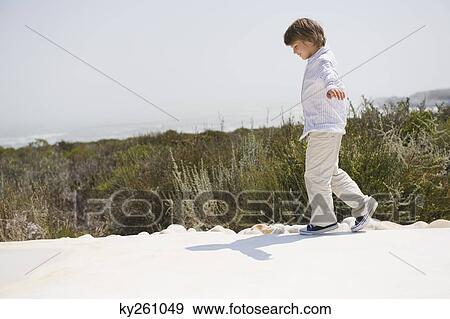 Boy walking at the poolside View Large Photo Image Stock Photo - Boy walking at the poolside. Fotosearch