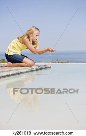 Girl playing on a platform at an infinity pool View Large Photo Image Stock Photo - Girl playing on a platform at an infinity pool. Fotosearch