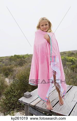 Girl standing on a boardwalk View Large Photo Image Stock Photo - Girl standing on a boardwalk. Fotosearch