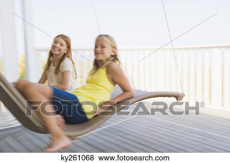 Two girls in a hammock View Large Photo Image Stock Photo - Two girls in a hammock. Fotosearch
