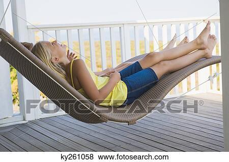 Stock Photo - Two girls lying in a hammock. Fotosearch