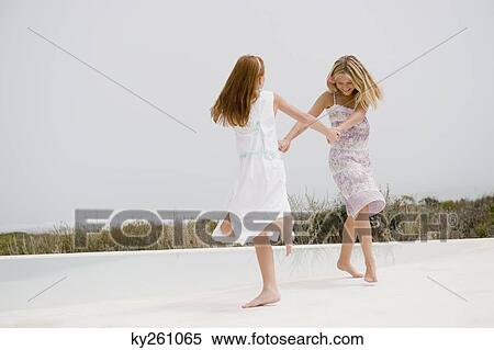 Two girls playing at the poolside View Large Photo Image Stock Photography - Two girls playing at the poolside. Fotosearch