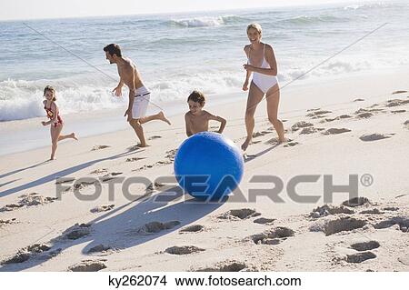Family enjoying vacations on the beach View Large Photo Image Picture - Family enjoying vacations on the beach. Fotosearch