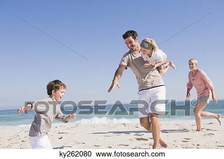 Family enjoying vacations on the beach View Large Photo Image Stock Image - Family enjoying vacations on the beach. Fotosearch