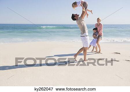 Family enjoying vacations on the beach View Large Photo Image Stock Photo - Family enjoying vacations on the beach. Fotosearch