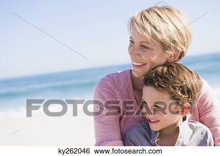 Family enjoying vacations on the beach View Large Photo Image Stock Photograph - Family enjoying vacations on the beach. Fotosearch