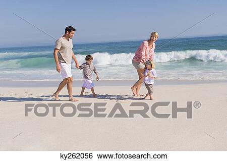 Stock Photograph - Family enjoying vacations on the beach. Fotosearch