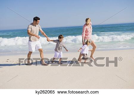 Family enjoying vacations on the beach View Large Photo Image Stock Photography - Family enjoying vacations on the beach. Fotosearch