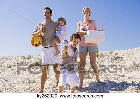 Stock Image - Family on vacations on the beach. Fotosearch
