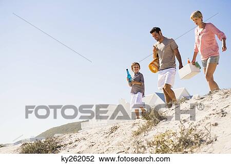 Stock Image - Family on vacations on the beach. Fotosearch