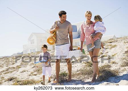 Stock Image - Family on vacations on the beach. Fotosearch