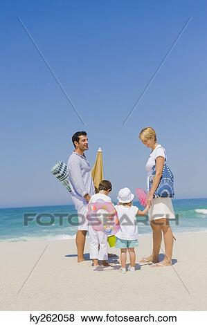 Stock Photo - Family on vacations on the beach. Fotosearch
