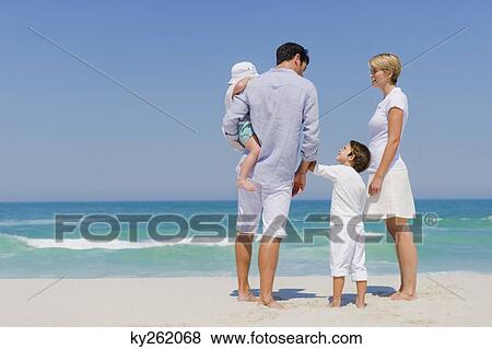 Stock Photo - Family on vacations on the beach. Fotosearch