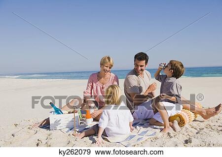 Stock Photo - Family on vacations on the beach. Fotosearch