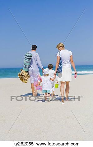 Stock Photography - Family on vacations on the beach. Fotosearch
