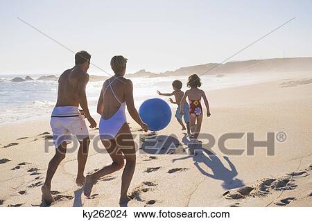 Picture - Family playing with a beach ball. Fotosearch