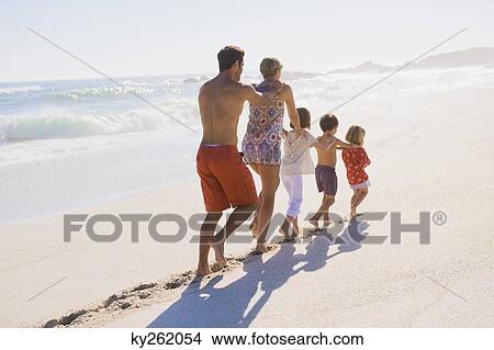 Family walking on the beach in train formation View Large Photo Image Picture - Family walking on the beach in train formation. Fotosearch