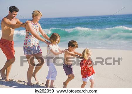 Family walking on the beach in train formation View Large Photo Image Stock Photo - Family walking on the beach in train formation. Fotosearch