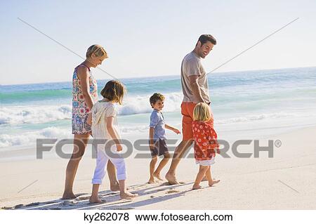 Family walking on the beach View Large Photo Image Stock Photo - Family walking on the beach. Fotosearch